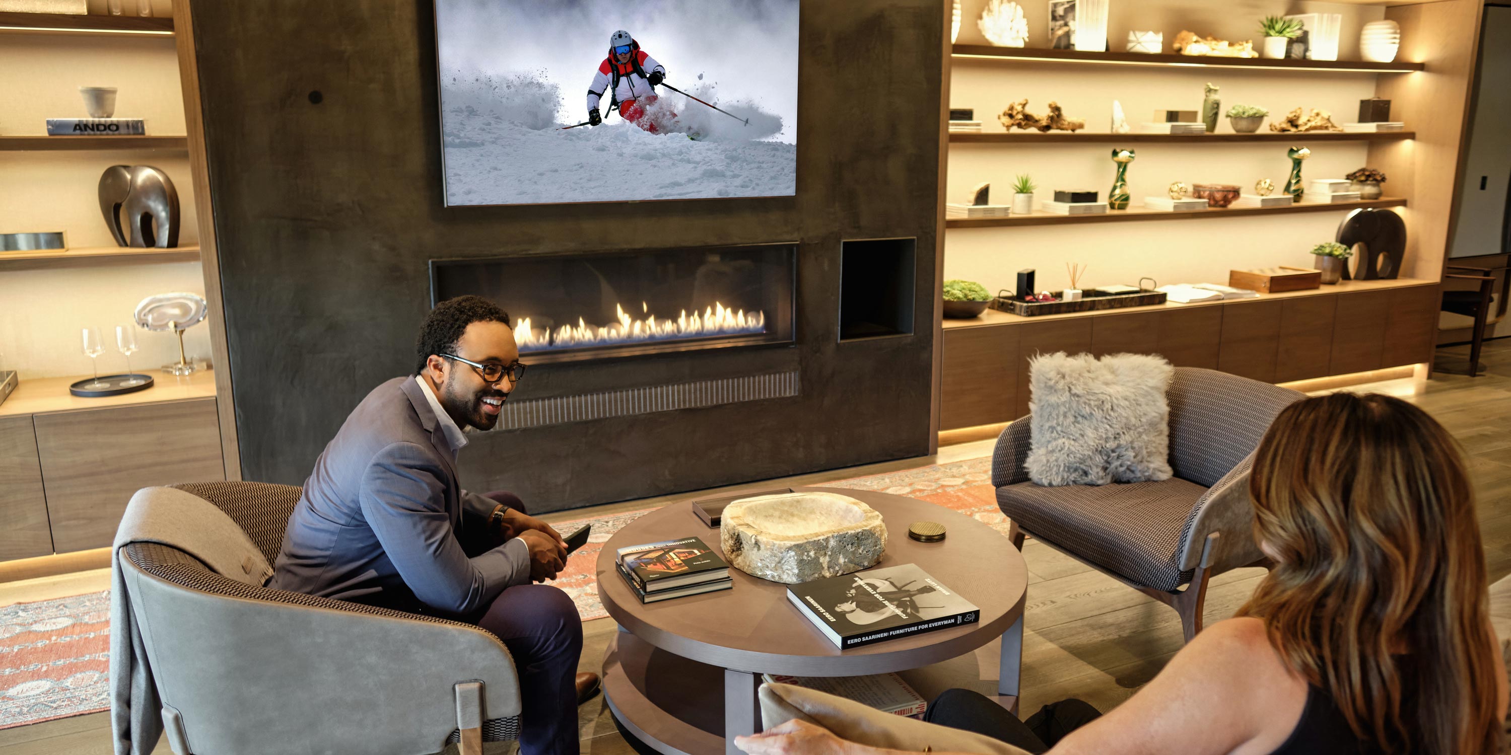 couple laughing on a couch in a living room with Josh AI technology