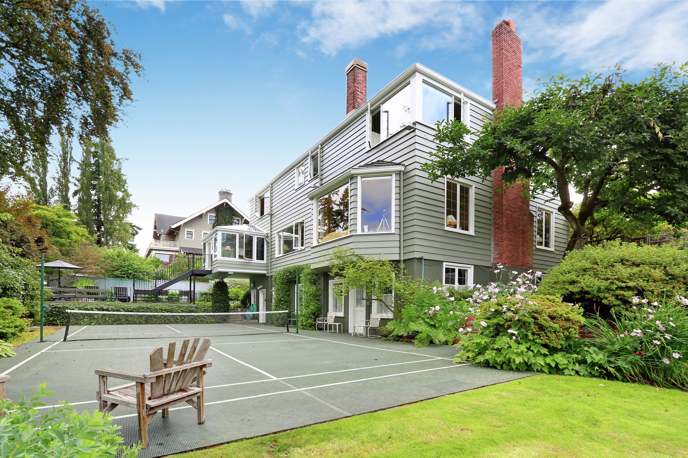 home with shiplap and tennis court in backyard